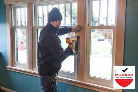 Emerald City Energy employee installing new replacement windows.